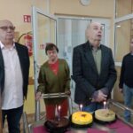 Kobieta i dwaj starsi mężczyźni i yrzy torty ze świeczkami przed nimi